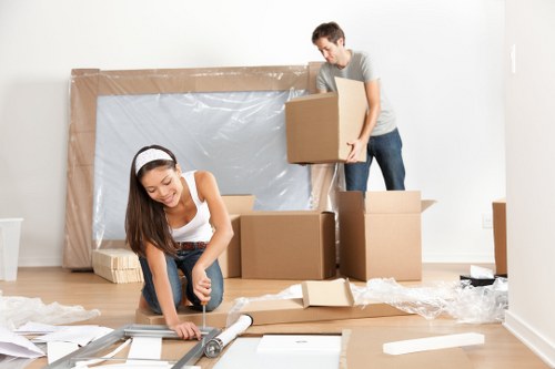Small removals van loading furniture in Kentishtown