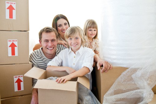 Boxes and furniture being moved through an apartment staircase